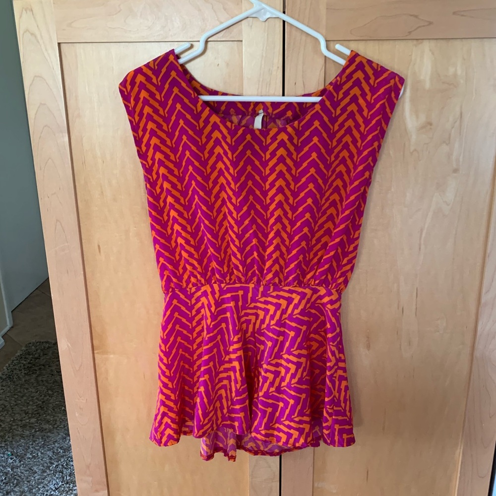 Peplum style pink and orange top with open back